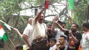 Prakash Raj waves the Indian Constitution at CJP's Chalo Sansad march in New Delhi.
