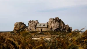 This 160-year-old tiny French cottage is squeezed between two rocks and off limits