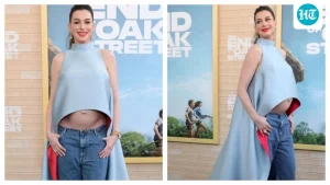 Anne Hathaway flaunts baby bump in silk top and jeans for The End of Oak Street's